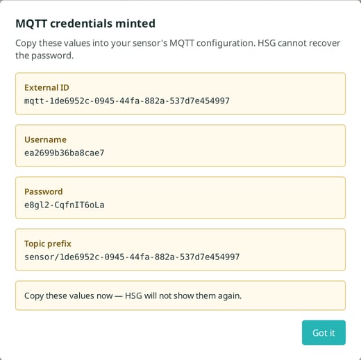 The MQTT credentials minted dialog showing the external ID, username, password and topic prefix